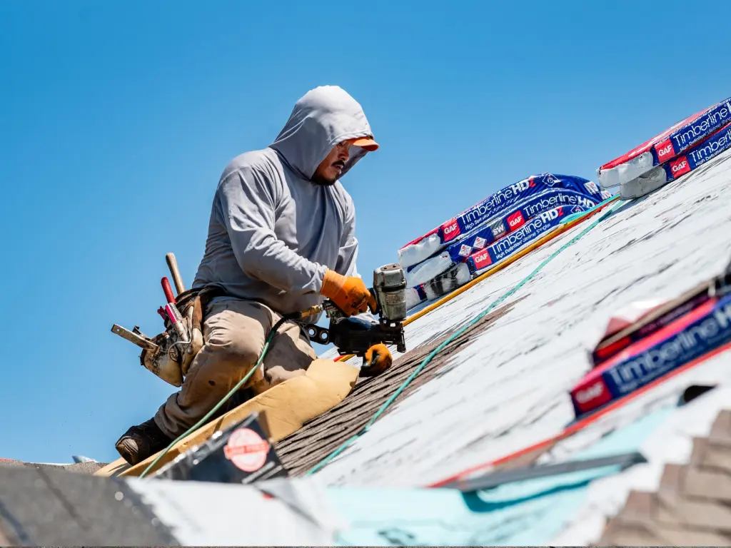 A man is working on a roof.